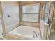 Bathroom with a large soaking tub and shower at 6944 Runner Oak Dr, Wesley Chapel, FL 33545