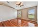 Well-lit bedroom with hardwood floors and ceiling fan at 6944 Runner Oak Dr, Wesley Chapel, FL 33545