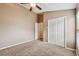 Well-lit bedroom featuring a double-door closet and ceiling fan at 6944 Runner Oak Dr, Wesley Chapel, FL 33545