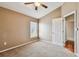 Spacious bedroom with carpeted floor, ceiling fan, and window with blinds at 6944 Runner Oak Dr, Wesley Chapel, FL 33545