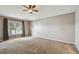 Large bedroom with neutral walls, carpeting, and a ceiling fan at 6944 Runner Oak Dr, Wesley Chapel, FL 33545