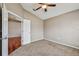 Bedroom with carpet, double doors, and view to living room at 6944 Runner Oak Dr, Wesley Chapel, FL 33545