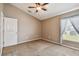 Bright bedroom with window, closet, and ceiling fan at 6944 Runner Oak Dr, Wesley Chapel, FL 33545