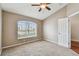 Bedroom with carpet, large window, and ceiling fan at 6944 Runner Oak Dr, Wesley Chapel, FL 33545