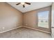 Bright bedroom with ceiling fan and window at 6944 Runner Oak Dr, Wesley Chapel, FL 33545