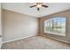 Bedroom with carpet, large window, and ceiling fan at 6944 Runner Oak Dr, Wesley Chapel, FL 33545