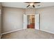 Bedroom with carpet, double doors, and view to living room at 6944 Runner Oak Dr, Wesley Chapel, FL 33545