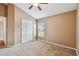 Bedroom with double door closet and ceiling fan at 6944 Runner Oak Dr, Wesley Chapel, FL 33545