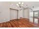 Bright dining room with hardwood floors and chandelier at 6944 Runner Oak Dr, Wesley Chapel, FL 33545