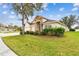 House exterior with a three-car garage and manicured lawn at 6944 Runner Oak Dr, Wesley Chapel, FL 33545