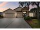 Two-story house with three-car garage and stone accents at 6944 Runner Oak Dr, Wesley Chapel, FL 33545