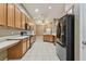 Kitchen with wood cabinets and black appliances at 6944 Runner Oak Dr, Wesley Chapel, FL 33545