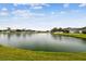 Peaceful lake view with lush green grass at 6944 Runner Oak Dr, Wesley Chapel, FL 33545