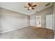 Main bedroom with carpet, ceiling fan, and door to bathroom at 6944 Runner Oak Dr, Wesley Chapel, FL 33545