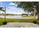 Charming patio with string lights overlooking a lake at 6944 Runner Oak Dr, Wesley Chapel, FL 33545