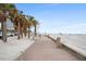 Beachfront walkway with palm trees and beach access at 710 Seminole St, Clearwater, FL 33755