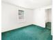 Bright bedroom with green carpet and a window at 710 Seminole St, Clearwater, FL 33755