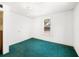 Small bedroom with green carpet and a window at 710 Seminole St, Clearwater, FL 33755