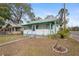 Quaint bungalow with white siding, green accents, and a porch at 710 Seminole St, Clearwater, FL 33755