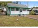 Small house with teal trim and small front yard at 710 Seminole St, Clearwater, FL 33755