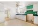 White kitchen cabinets and green accents. Needs updating at 710 Seminole St, Clearwater, FL 33755