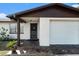 House exterior with front door and attached garage at 7310 Oakshire Dr, Port Richey, FL 34668