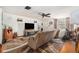 Living room with a brown sectional sofa, a large TV, and a ceiling fan at 7310 Oakshire Dr, Port Richey, FL 34668