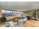 Screened porch with table and chairs, overlooks backyard at 7310 Oakshire Dr, Port Richey, FL 34668