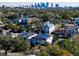 Aerial view of a house and neighborhood with city skyline in the background at 818 W Adalee St, Tampa, FL 33603