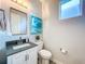 Modern bathroom with white vanity, toilet, and stylish art at 818 W Adalee St, Tampa, FL 33603