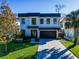 Modern two-story house with a dark-gray roof and paver driveway at 818 W Adalee St, Tampa, FL 33603