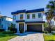 Modern two-story house with a dark-gray roof and paver driveway at 818 W Adalee St, Tampa, FL 33603