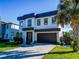 Modern two-story house with a dark-gray roof and paver driveway at 818 W Adalee St, Tampa, FL 33603