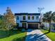 Modern two-story home with a paver driveway and landscaped lawn at 818 W Adalee St, Tampa, FL 33603