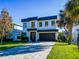 Modern two-story home with dark brown garage door and paver driveway at 818 W Adalee St, Tampa, FL 33603