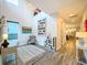 Bright home office features hardwood floors, a gray armchair, and views into the kitchen at 818 W Adalee St, Tampa, FL 33603