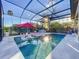 Spacious pool area with covered patio and sun loungers at 818 W Adalee St, Tampa, FL 33603