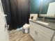 Updated bathroom with white vanity, gray countertop and tiled floor at 895 64Th S Ave, St Petersburg, FL 33705