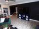 Living area with dark walls and wood-look floors at 895 64Th S Ave, St Petersburg, FL 33705