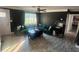 Spacious living room with dark walls and a green couch at 895 64Th S Ave, St Petersburg, FL 33705