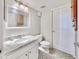 Simple bathroom with granite countertop, white cabinets, and patterned floor at 9934 Peninsular Dr, Gibsonton, FL 33534