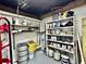 Storage area with shelves holding paint, tires, and other items at 9934 Peninsular Dr, Gibsonton, FL 33534