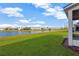 Backyard with grassy area and lake view at 10112 Haverhill Ridge Dr, Riverview, FL 33578