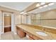 Double vanity bathroom with granite countertop and large mirror at 10112 Haverhill Ridge Dr, Riverview, FL 33578