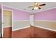 Bedroom with hardwood floors and lavender walls at 10112 Haverhill Ridge Dr, Riverview, FL 33578