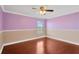 Bedroom with hardwood floors and lavender walls at 10112 Haverhill Ridge Dr, Riverview, FL 33578
