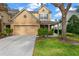 Two-story house with tan siding, two-car garage, and landscaped lawn at 10112 Haverhill Ridge Dr, Riverview, FL 33578