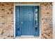 Blue front door with sidelights and brick surround at 10112 Haverhill Ridge Dr, Riverview, FL 33578
