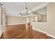 Open living room featuring hardwood floors and a chandelier at 10112 Haverhill Ridge Dr, Riverview, FL 33578