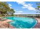 Community pool with lake view and plenty of lounge chairs at 10112 Haverhill Ridge Dr, Riverview, FL 33578